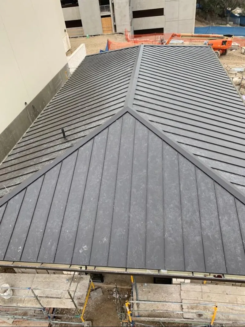 Commercial metal roof construction with crane equipment in Florence